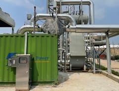 Row of gas genset containers with SCR systems at a landfill site, further photo